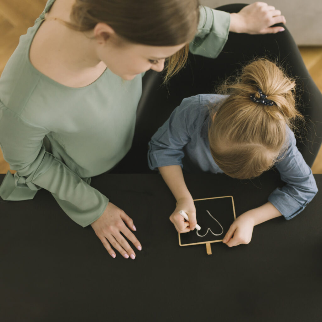 mothers day concept with kid drawing with chalk