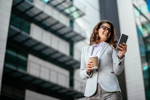 How to run your Life like a Business in 2024 2 Lady strides confidently through a busy cityscape, holding a clipboard and coffee, with skyscrapers in the background. (In your life, as you navigate challenges, you too can exude this same confident determination.)
