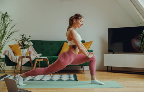 How to Get a Better Night Sleep 4 A person stretches on a yoga mat bathed in sunlight, promoting healthy daytime exercise for better sleep