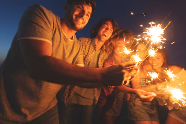 Beyond the Sparklers: Patriotic Poem 4 A family gathered around a bonfire on a summer night, holding sparklers that cast a warm glow on their faces