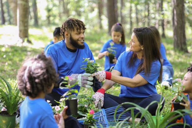 Family planting trees together in a park, contributing to a healthy environment and a more sustainable future with easy steps