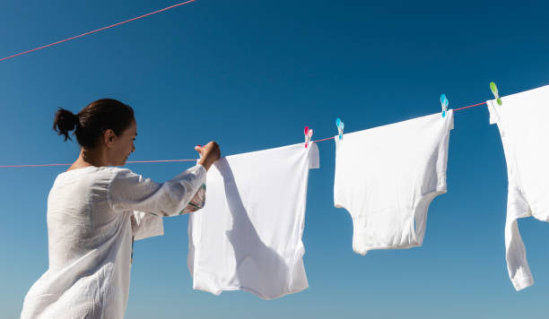 Air drying clothes on a clothesline to dry sustainably, reducing environmental impact.