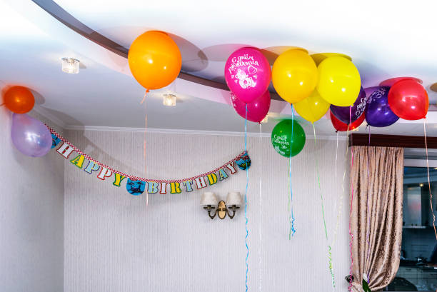 Colorful balloons and streamers decorate a room for a birthday party