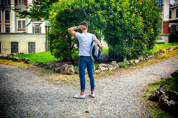 Person at a crossroads, representing decision-making and choosing the right path to fulfill one's passion and purpose